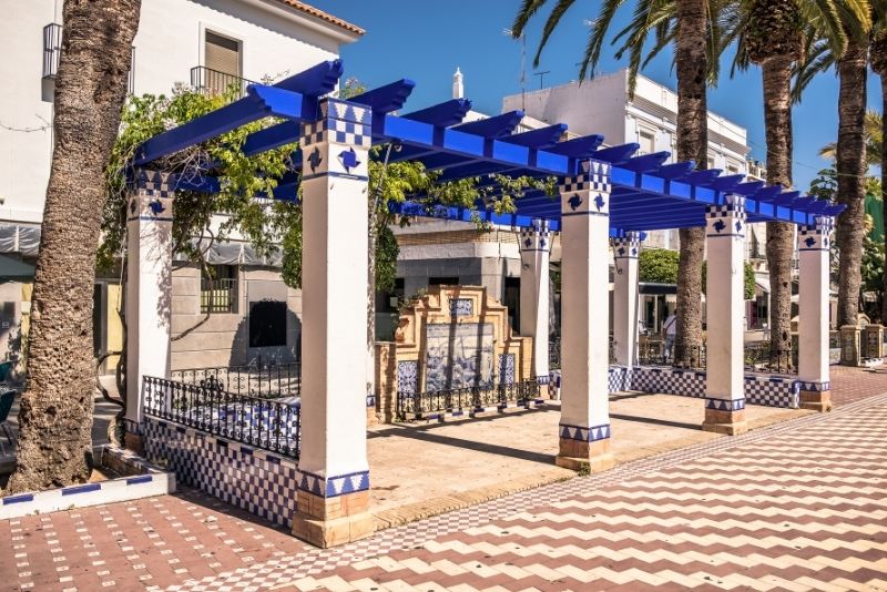 blue painted pergolas providing a waiting shed