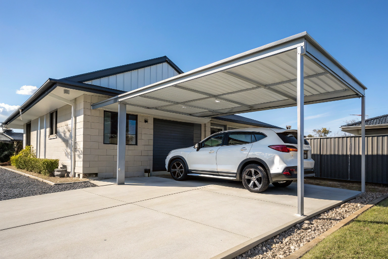 Modern single carport with skillion roof design and steel frame protecting white car in Australian driveway